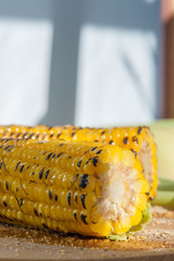 Poster - two grilled corn on a wooden plate