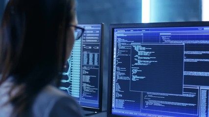 Aufkleber - Over The Shoulder Footage of Female IT Engineer Working in Monitoring Room. She Works with Multiple Displays. Shot on RED EPIC-W 8K Helium Cinema Camera.
