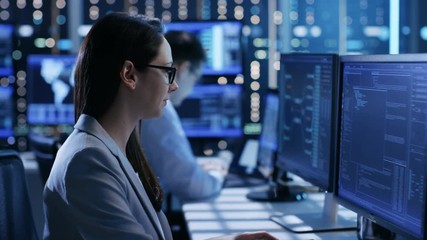 Aufkleber - Close-up Footage of Female IT Engineer Working in Monitoring Room. She Works with Multiple Displays. Shot on RED EPIC-W 8K Helium Cinema Camera.