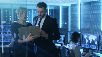 Aufkleber - In System Control Room Female and Male Top Managers Have Discussion. In the Background Professional Engineers Working with Multiple Displays Each. Shot on RED EPIC-W 8K Helium Cinema Camera.