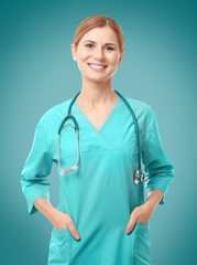 Poster - Beautiful young doctor with stethoscope on white background