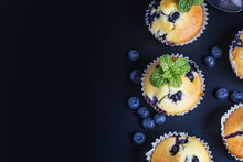Blueberry Muffins With Powdered Sugar And Fresh Berries