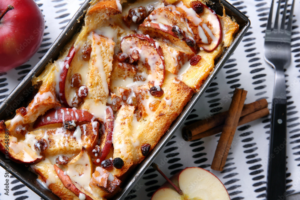 Freshly baked bread pudding in casserole dish, closeup