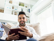 © Jasmin Merdan - Young confident man reading book at modern home