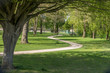 © LuXpics - Sinuous path on an idyllic spring european park with green lawn and beautiful old trees