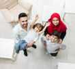© Jasmin Merdan - Happy Arabic Muslim family at modern home having fun and good time together