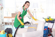 © Africa Studio - Young female cleaner at work in living room