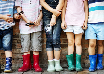 Wall Mural - Group of kindergarten kids friends holding magnifying glass for explore