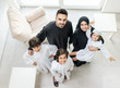 © Jasmin Merdan - High angle view portrait of happy Arabic Muslim family at new modern home