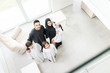 © Jasmin Merdan - High angle view portrait of happy Arabic Muslim family at new modern home