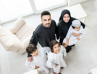 Wall Mural - High angle view portrait of happy Arabic Muslim family at new modern home