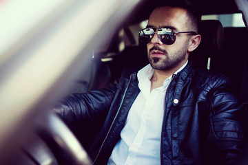 Wall Mural - Young confident man with a sport car