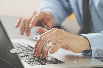 Poster - close up of businessman typing keyboard with laptop computer on wooden desk in modern office with virtual reality icon diagram