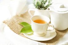 Close Up Organic Tea In White Cup With Green Leaf , Tea Ceremony Time Concept