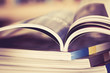 Close up opened magazine page with  blurry bookshelf background for publication concept