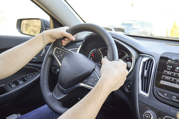 Man with hands on driving wheel