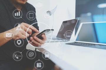 businessman working with smart phone and digital tablet and laptop computer in modern office