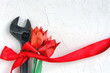 wrench with red ribbon and origami tulip