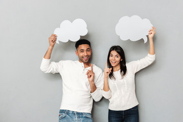 Sticker - Cheerful couple pointing their fingers up and holding bubbles