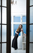 © Volodymyr - Pretty girl in black dress through open doors