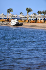 Wall Mural - yacht at beautiful blue sea shore and white motor boat