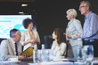© gpointstudio - Five business people in conference room