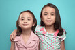 © Leo Lintang - Happy two asian kids embracing and standing together