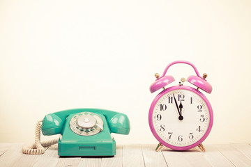 Fototapete - Retro telephone and alarm clock on table