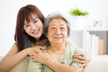 Grandmother And Granddaughter. Young Woman Carefully Takes Care Of Old Woman