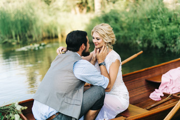 Young wedding couple posing on the boat