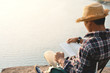 © sawitreelyaon - Happy Asian hipster man reading a book in nature background, Relax time on holiday concept travel , color of vintage tone and soft focus
