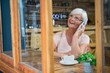 © wavebreak3 - Senior woman talking on mobile phone while having coffee