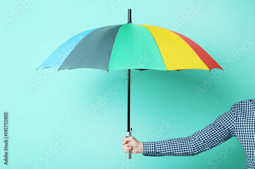Colorful Umbrella In Male Hand On Green Background Kaufen Sie Dieses Foto Und Finden Sie Ahnliche Bilder Auf Adobe Stock Adobe Stock