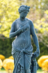 Poster - Statue of Goddess in a Classical Style. Antic statue of the Nymph with dog in the park.