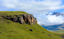 Scenic Nature Panorama Of  Drakensberg Landscape, Giants Castle, South Africa, Mountains And A Green Valley With Dense Clouds And A Blue Sky On A Sunny Day