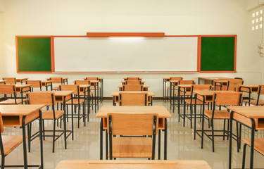 Wall Mural - school classroom with desks chair wood, and greenboard in high school thailand, vintage tone educati