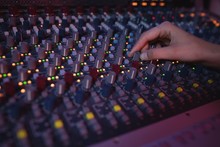 Hands Of Female Audio Engineer Using Sound Mixer