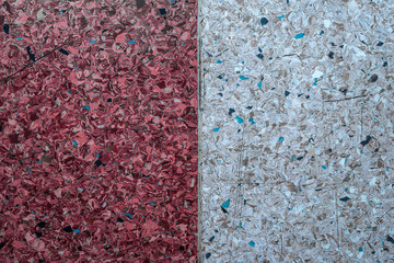 Background of a concrete wall and multi-colored gravel with a texture of two vertical parts - white and red. Horizontal frame