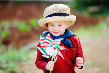 Wall Mural - Happy toddler boy holding Italian flag outdoors