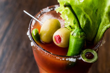 Bloody Mary Cocktail With Green Olive, Pepper, Lettuce, Salt And Ice.