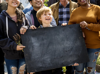 Wall Mural - Boy holding copyspace blackboard at farmers market festival