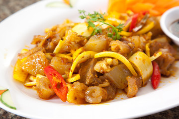 Wall Mural - Fried sauteed beef tendon with onion and chili on white dish