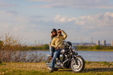 Fototapeta  - Beautiful young couple with a classic motorcycle