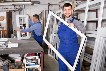 Wall Mural - Young worker is demonstrating PVC manufacturing output