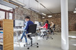 © Westend61 - Group of people working in creative office, looking content