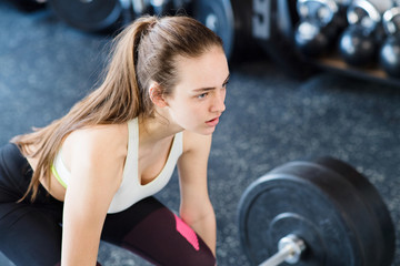 Sticker - Beautiful young fit woman in gym lifting heavy barbell