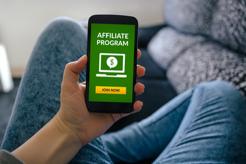 Girl holding smart phone with affiliate program concept on screen. All screen content is designed by me