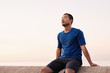 © mavoimages - Athletic Asian man taking a breather during a morning run