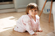 © Drobot Dean - Beautiful little girl in pajamas on wooden floor