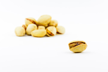 Isolated roasted pistachios nuts on a white background